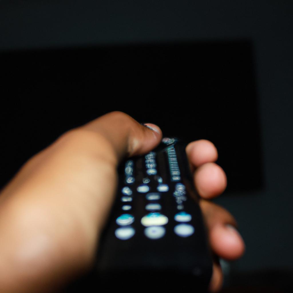 Person holding a TV remote